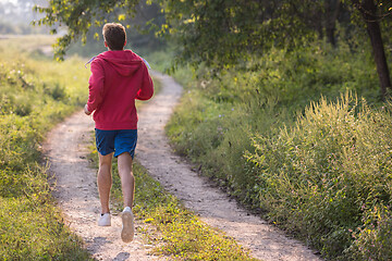 Image showing man jogging along a country road