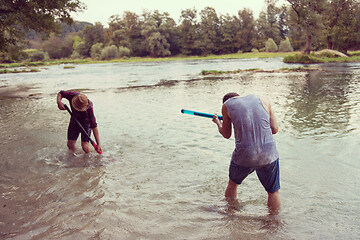 Image showing young men having fun with water guns