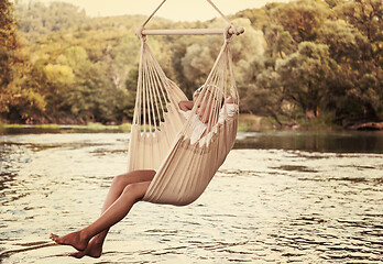 Image showing blonde woman resting on hammock