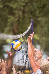 Image showing group of young friends playing Beach volleyball