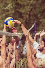 Image showing group of young friends playing Beach volleyball