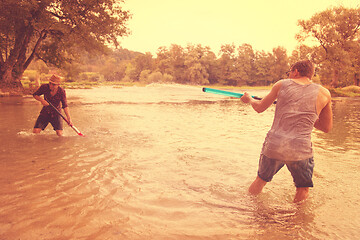 Image showing young men having fun with water guns