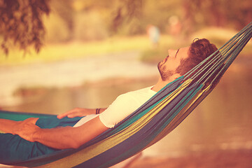 Image showing man resting on hammock