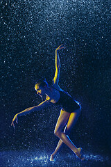 Image showing Two young female ballet dancers under water drops