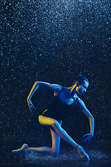 Image showing Two young female ballet dancers under water drops