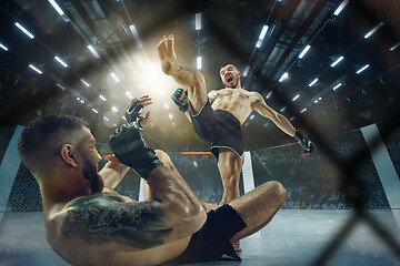 Image showing Two professional boxers boxing on the ring