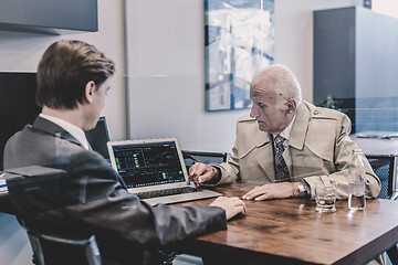 Image showing Financial advisor consulting senior client with his investment strategy.