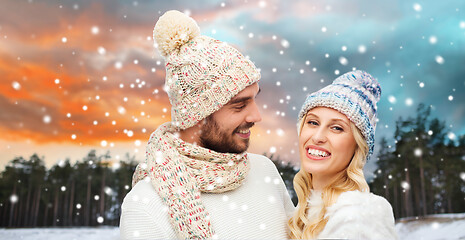 Image showing smiling couple in winter clothes hugging