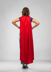 Image showing back view of young woman in red superhero cape