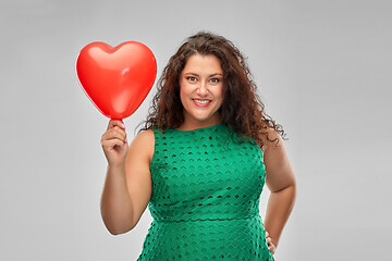 Image showing happy woman holding red heart shaped balloon