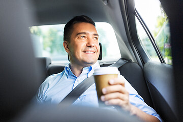 Image showing businessman with takeaway coffee on car back seat