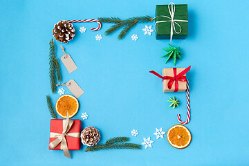 Image showing frame of gifts, fir branches, tags and decorations