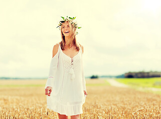 Image showing happy young woman in flower wreath on cereal field