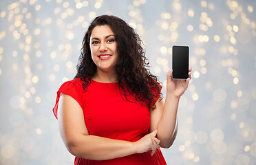 Image showing happy woman in red dress showing smartphone