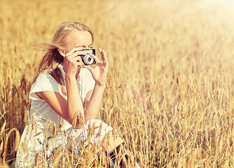 Image showing woman taking picture with camera in cereal field