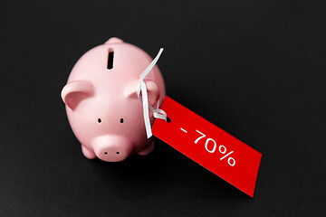 Image showing piggy bank with red sale tag on black