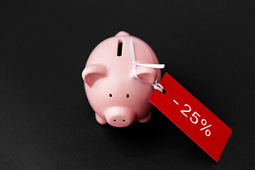 Image showing piggy bank with red sale tag on black