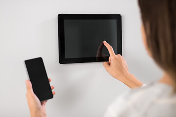 Image showing woman using tablet computer and smartphone