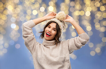 Image showing woman in winter hat and sweater on christmas