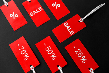 Image showing red tags with discount signs on black background