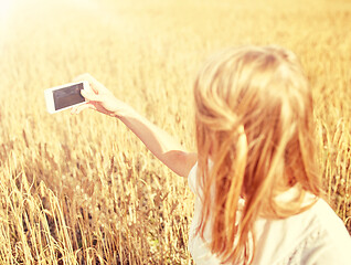 Image showing close up of girl with smartphone on cereal field