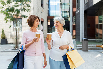 Image showing senior women with shopping bags and coffee in city