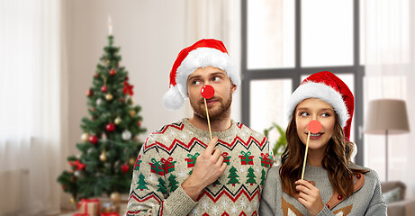 Image showing couple with christmas party props in ugly sweaters