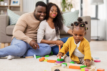 Image showing african family playing with baby daughter at home