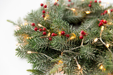 Image showing christmas fir wreath with berries and lights