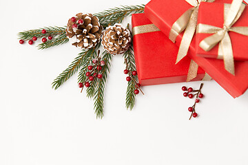 Image showing christmas gifts and fir branches with pine cones