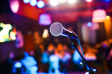 Image showing Microphone on stage against a background of auditorium.