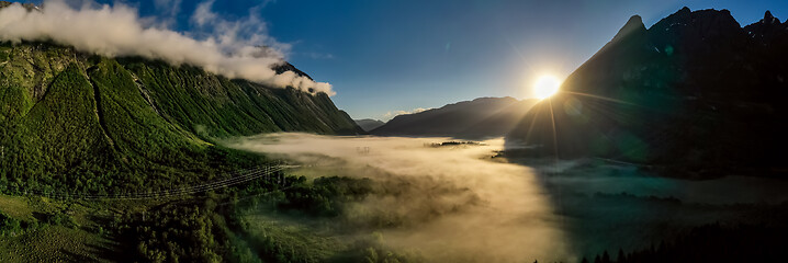 Image showing Morning mist over the valley among the mountains in the sunlight