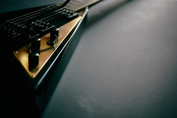 Image showing Black V shape electric guitar on dark grunge background.