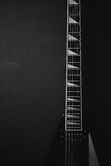 Image showing Black V shape electric guitar on dark grunge background.