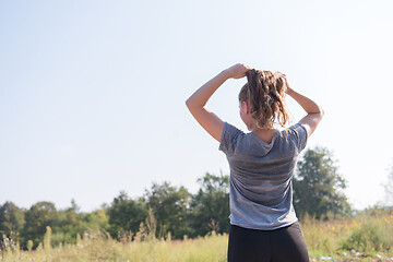 Image showing woman jogging along a country road