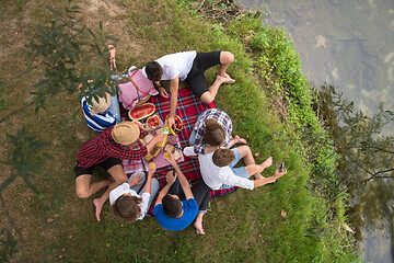 Image showing top view of group friends enjoying picnic time