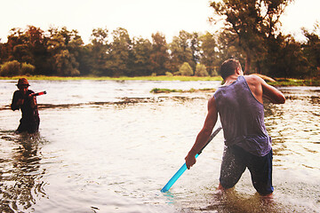 Image showing young men having fun with water guns