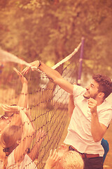 Image showing group of young friends playing Beach volleyball