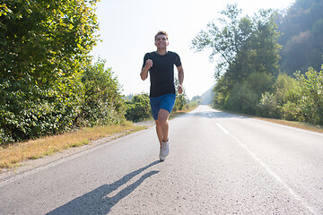 Image showing man jogging along a country road