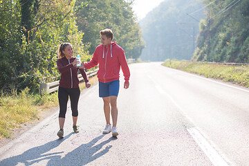 Image showing young couple jogging along a country road