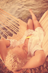 Image showing blonde woman resting on hammock