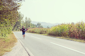 Image showing happy couple jogging along a country road