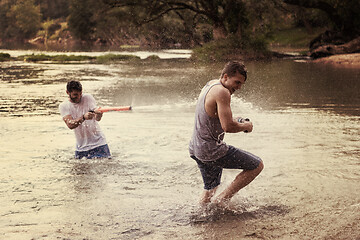 Image showing young men having fun with water guns