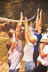 Image showing group of young friends playing Beach volleyball