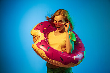 Image showing Beautiful woman in neon light isolated on blue studio background