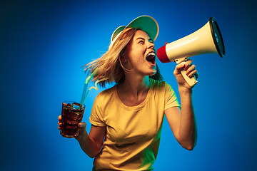 Image showing Beautiful woman in neon light isolated on blue studio background