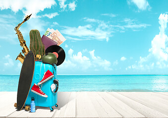 Image showing Collage of luggage for travel in front of ocean view