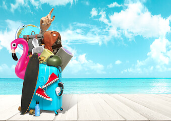 Image showing Collage of luggage for travel in front of ocean view