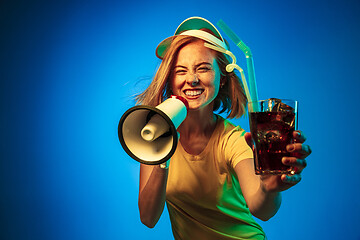 Image showing Beautiful woman in neon light isolated on blue studio background