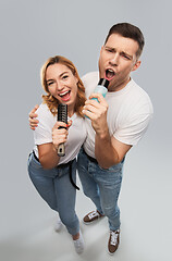 Image showing happy couple singing to hairbrush and lotion